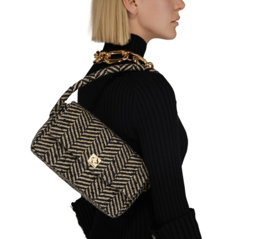 A model is carrying Anine Bing's Nico bag. 