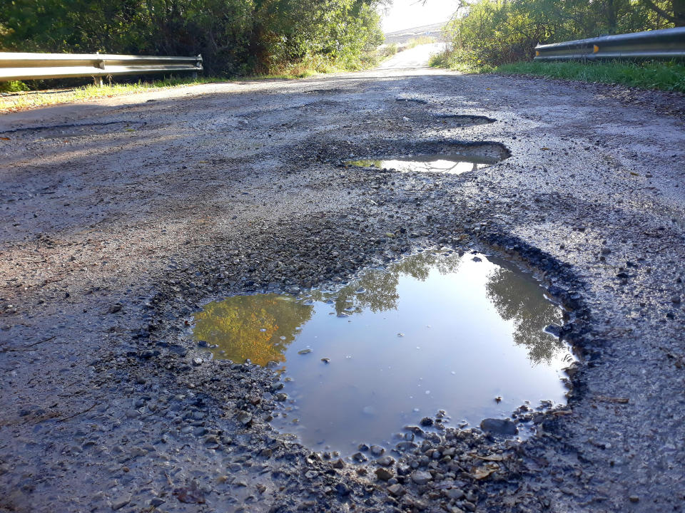 Puddles in potholes in a road