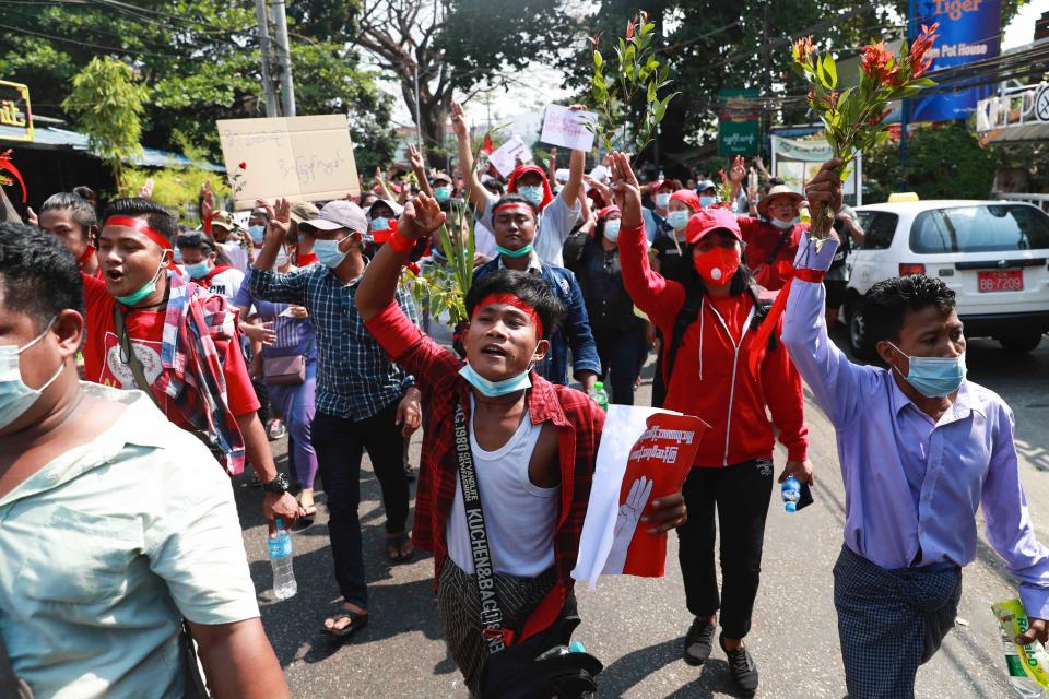 Protesters flash the three-fingered salute as they march in Yangon, Myanmar on Sunday, Feb. 7, 2021. Thousands of people rallied against the military takeover in Myanmar's biggest city on Sunday and demanded the release of Aung San Suu Kyi, whose elected government was toppled by the army that also imposed an internet blackout. (AP Photo)