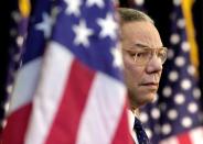 FILE - In this Feb. 15, 2001 file photo, Secretary of State Colin Powell looks on as President Bush addresses State Department employees at the State Department in Washington. Powell, former Joint Chiefs chairman and secretary of state, has died from COVID-19 complications. In an announcement on social media Monday, the family said Powell had been fully vaccinated. He was 84. (AP Photo/Kenneth Lambert)