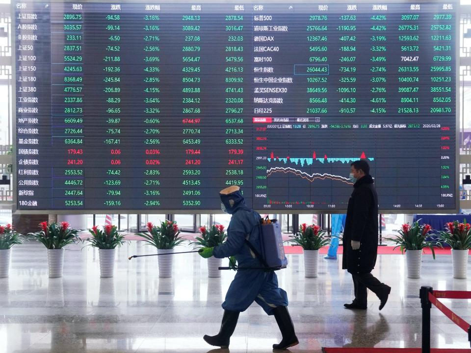 Worker with sanitizing equipment disinfects inside the Shanghai Stock Exchange building,amid novel coronavirus outbreak, at the Pudong financial district in Shanghai.JPG