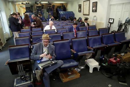 Glenn Thrush (L), chief White House political correspondent for the The New York Times, works in the briefing room after being excluded from a gaggle at the White House in Washington, U.S., February 24, 2017. REUTERS/Yuri Gripas