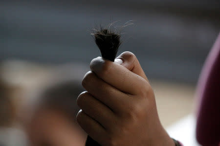 Freshly cut hair are collected into a bundle at Insein hair market in Yangon, Myanmar, June 18, 2018. REUTERS/Ann Wang