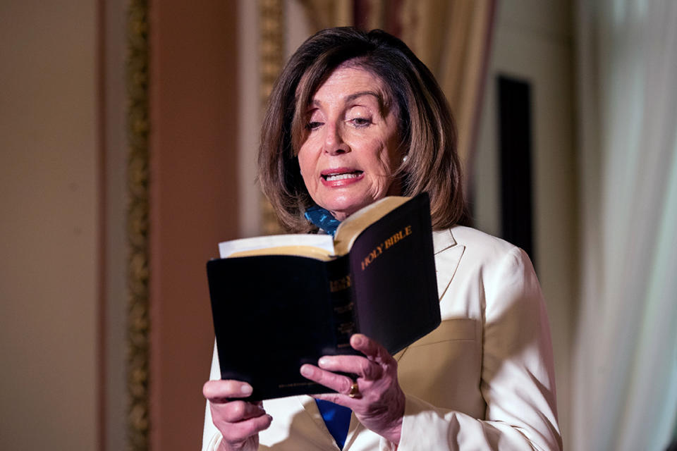 House Speaker Nancy Pelosi of Calif., reads from the Bible, as she reacts to President Donald Trump during a news conference at the U.S. Capitol in Washington, Tuesday, June 2, 2020. (AP Photo/Manuel Balce Ceneta)