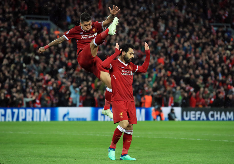 Liverpool’s Mohamed Salah and Roberto Firmino celebrate Salah’s second goal of the Champions League semifinal first leg against Roma. (Getty)