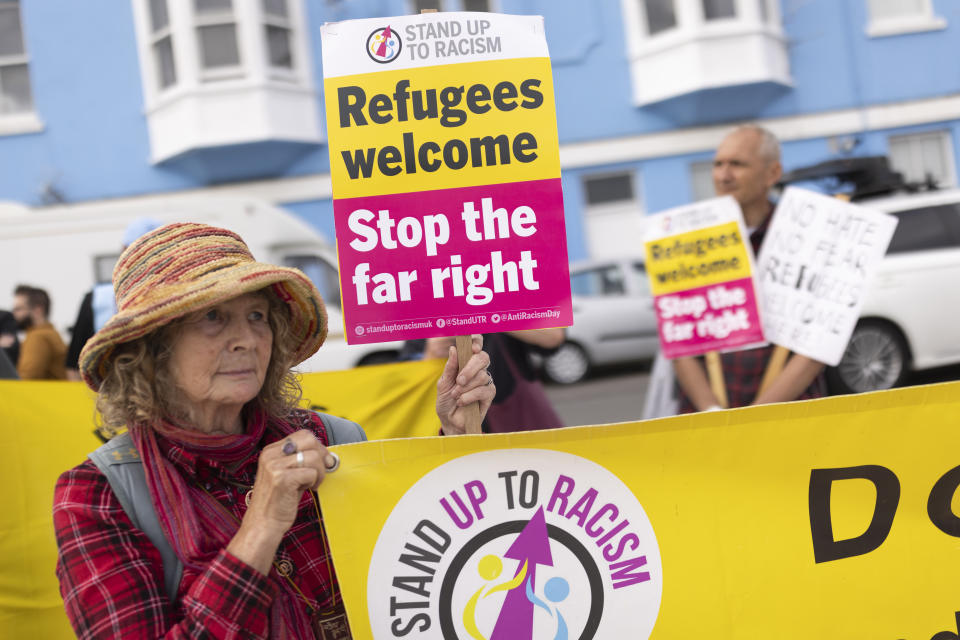 PORTLAND, ENGLAND - JULY 18: Members of Stand Up To Racism stage a counter demonstration outside the port entrance as the Bibby Stockholm migrant barge arrives at Portland Harbour on July 18, 2023 in Portland, England. The Bibby Stockholm arrives in Portland, after a refit at Falmouth, to serve as living quarters for up to 500 asylum seekers to the UK. (Photo by Dan Kitwood/Getty Images)