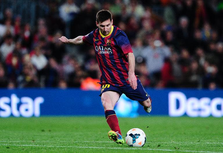 Barcelona's Argentinian forward Lionel Messi scores during the Spanish league football match FC Barcelona vs Athletic Club Bilbao at the Camp Nou stadium in Barcelona on April 20, 2014