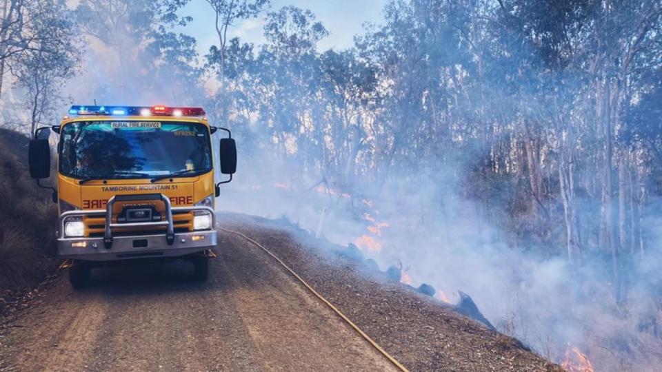 firefighters working to contain bushfires in queensland