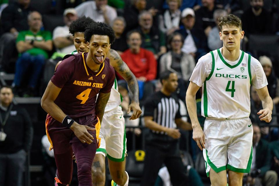 Arizona State guard Desmond Cambridge Jr., front left, reacts after making a 3-point basket as Oregon guard Rivaldo Soares, back left, and guard Brennan Rigsby, right, get back on offense during the first half of an NCAA college basketball game Thursday, Jan. 12, 2023, in Eugene, Ore. (AP Photo/Andy Nelson)