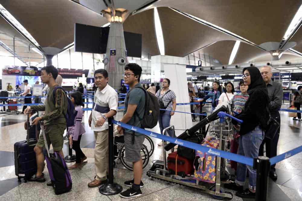 Travellers queue up to check-in for their flights at the Kuala Lumpur International Airport in Sepang August 24, 2019. ― Pictures by Miera Zulyana