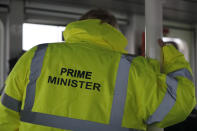 Britain's Prime Minister Boris Johnson wears safety clothing reading "Prime Minister" during a General Election campaign stop aboard a tog boat in the port of Bristol, England, Thursday, Nov. 14, 2019. Britain goes to the polls on Dec. 12. (AP Photo/Frank Augstein, Pool)