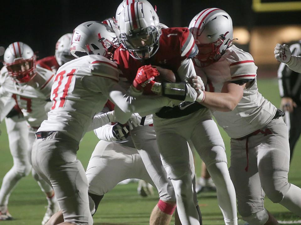 Canandaigua defenders wrap up a Niskayna runner during Friday's Class A quarterfinal.