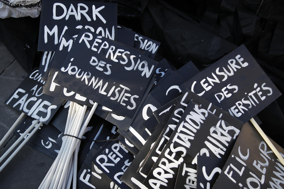 Posters against a security law that would restrict sharing images of police are seen during a demonstration Saturday, Nov. 28, 2020 in Paris. Critics of a proposed French security law in France that would restrict sharing images of police are gathering across the country in protest. Civil liberties groups and journalists are concerned that the measure will stymie press freedoms and allow police brutality to go undiscovered and unpunished. (AP Photo/Francois Mori)