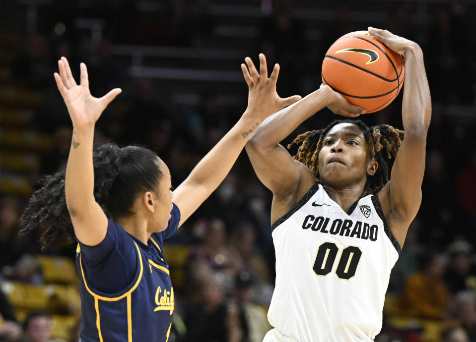 Colorado guard Jaylyn Sherrod, right, shoots over California guard Leilani McIntosh during the first half of an NCAA college basketball game Friday, Jan. 12, 2024, in Boulder, Colo. (AP Photo/Cliff Grassmick)