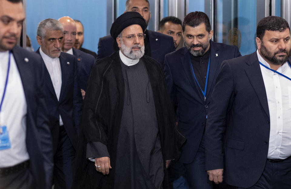 President of Iran Ebrahim Raisi, center, is escorted after an earlier arrival at United Nations headquarters at U.N. headquarters, Wednesday, Sept. 21, 2022. (AP Photo/Craig Ruttle)
