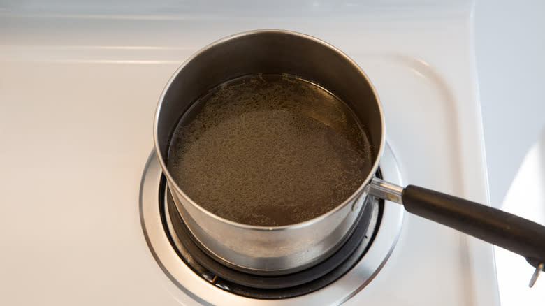 vegetable broth heating in pan