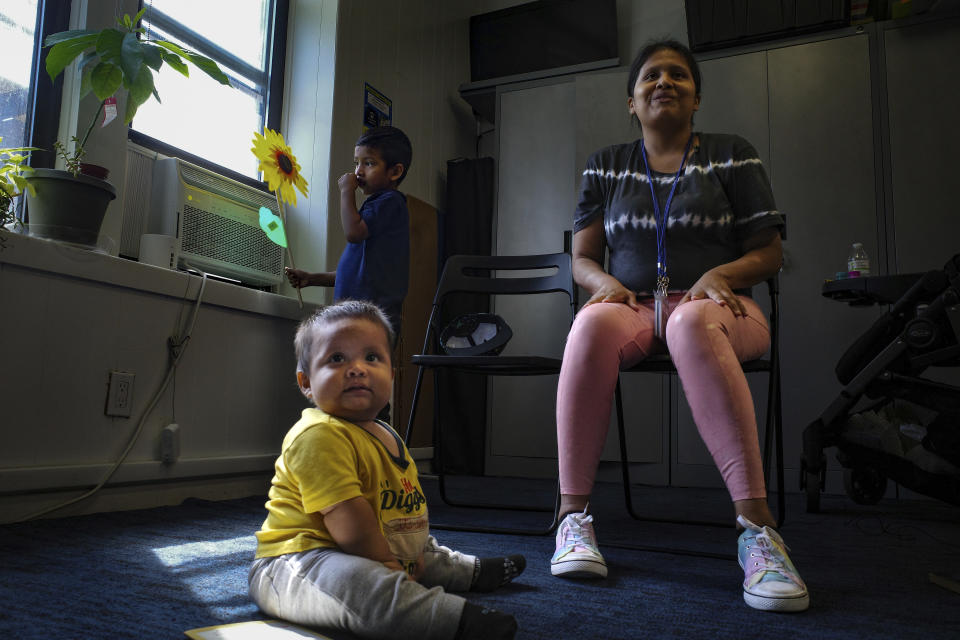 Kimberly Charchipulla sits for an interview with her sons an in New York on Tuesday, Sept. 5, 2023. Carchipulla's 5-year-old son will have his first day of school on Thursday after their family emigrated from Ecuador in June. Her family is among tens of thousands of recent arrivals to the city who have fled violence and disorder in central and South America. (AP Photo/Robert Bumsted)