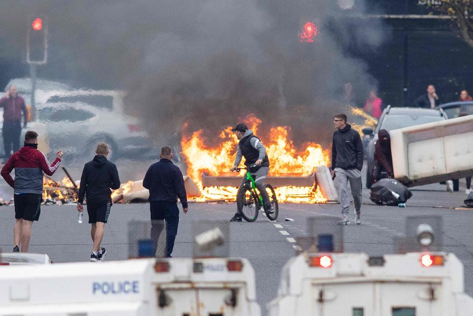 <p>Streets burn: unrest in west Belfast yesterday</p> (AFP via Getty Images)