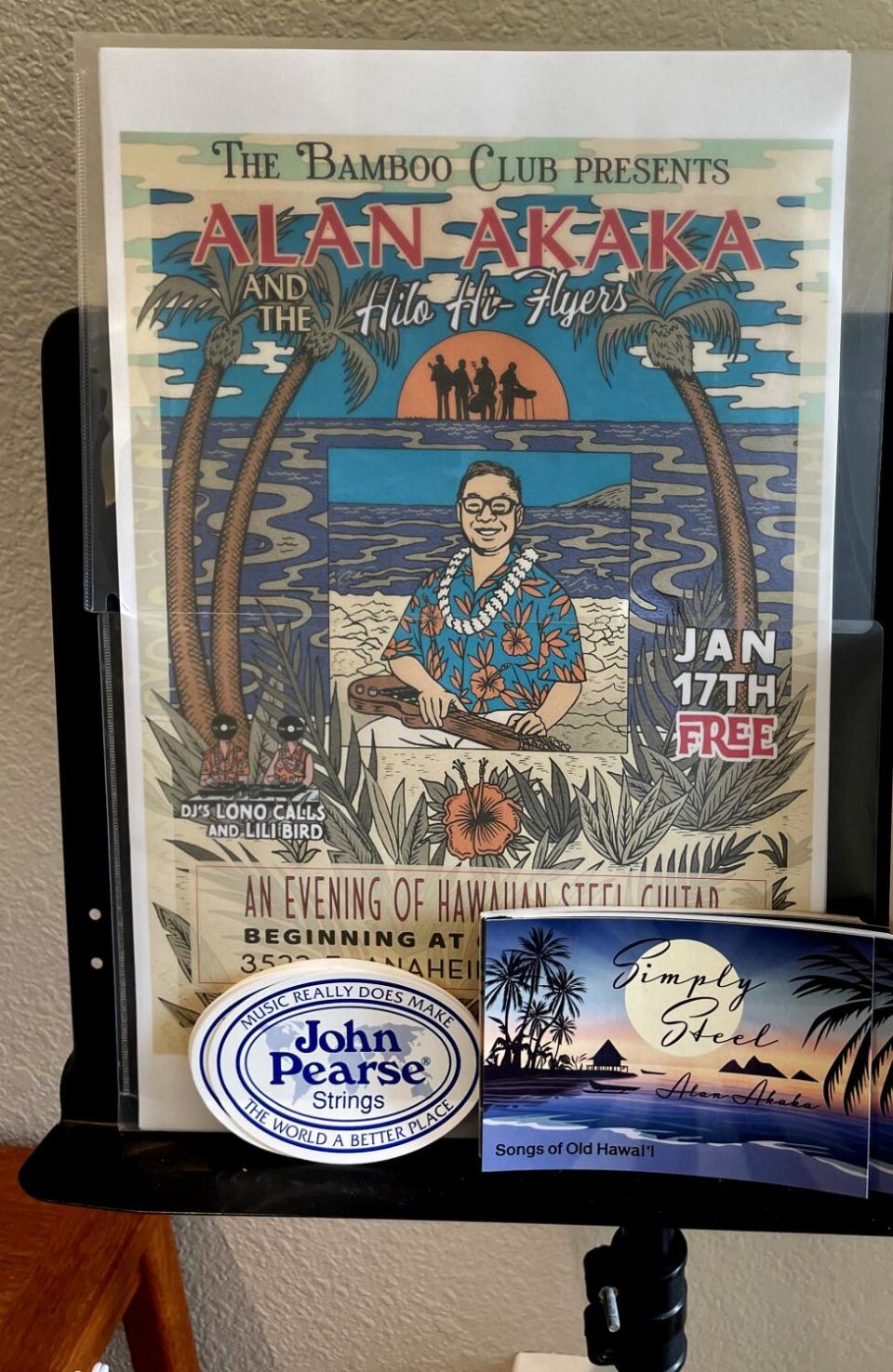 An Alan Akaka poster, postcards and other memorabilia on display.