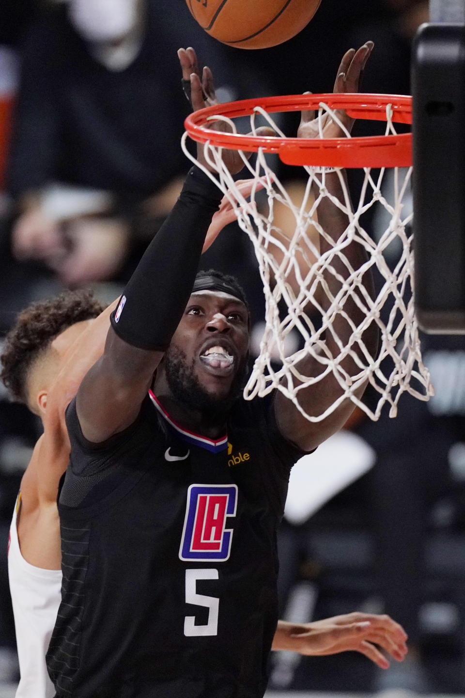 Los Angeles Clippers' Montrezl Harrell (5) shoots in front of Denver Nuggets' Michael Porter Jr. (1) in the second half of an NBA conference semifinal playoff basketball game Thursday, Sept 3, 2020, in Lake Buena Vista Fla. (AP Photo/Mark J. Terrill)