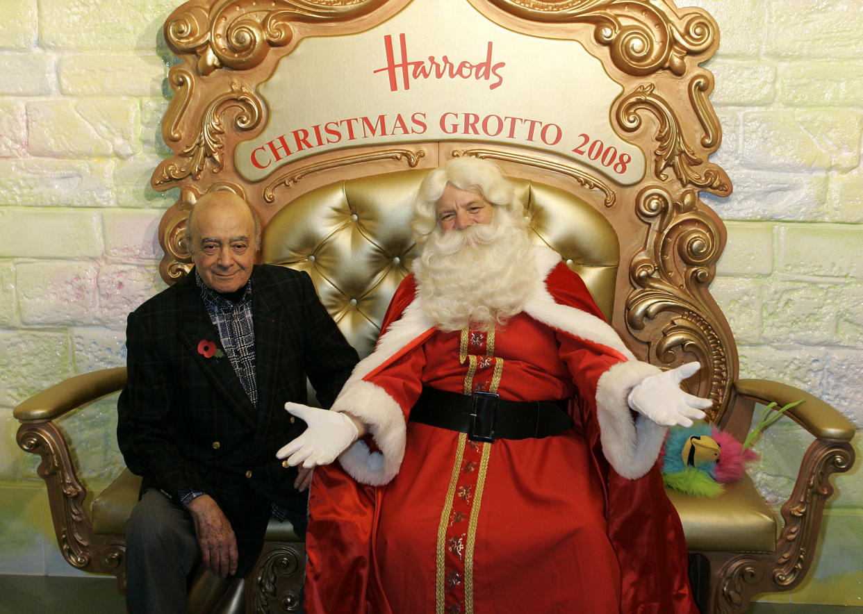 Harrods chairman Mohamed Al Fayed and a man dressed as Father Christmas pose for photographers in the Christmas grotto in the Harrods department store in London, Saturday, Nov. 1, 2008.  Saturday saw the official start to Christmas at Harrods as the annual Christmas parade brought a festive cheer to the crowd with street entertainers and performers.(AP Photo/Akira Suemori)