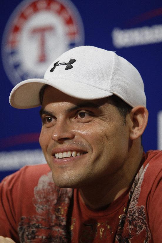 FILE - In this Aug. 18, 2009, file photo, Texas Rangers newly acquired catcher Ivan Rodriguez responds to questions during a press conference after arriving at the Texas Rangers Ballpark in Arlington before a baseball game against the Minnesota Twins. Tim Raines and Jeff Bagwell are likely to be voted into baseball's Hall of Fame on Wednesday, Jan. 18, 2017, when Trevor Hoffman and Ivan Rodriguez also could gain the honor. (AP Photo/Tony Gutierrez, File)