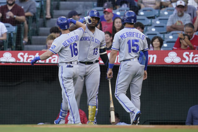 Kansas City Royals' Hunter Dozier, left, greets Whit Merrifield