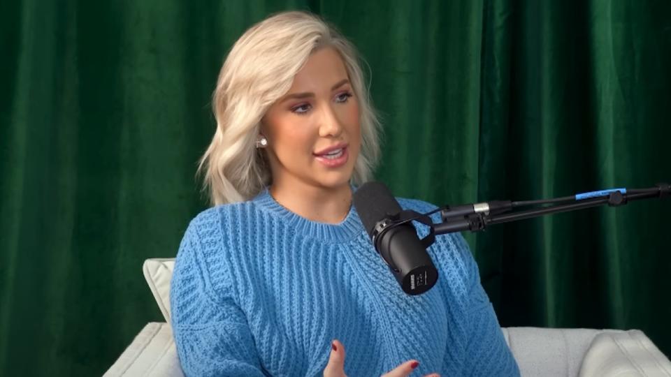 Savannah Chrisley talking into a microphone on the Unlocked podcast