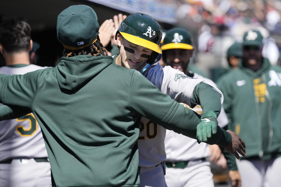 Oakland Athletics' Zack Gelof is greeted in the dugout after his three-run home run during the second inning of a baseball game against the Detroit Tigers, Sunday, April 7, 2024, in Detroit. (AP Photo/Carlos Osorio)