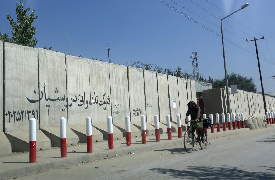 <p>An Afghan man pedals his bicycle past American University of Afghanistan in Kabul, Afghanistan, Monday, Aug. 8, 2016. (AP Photo/Rahmat Gul) </p>