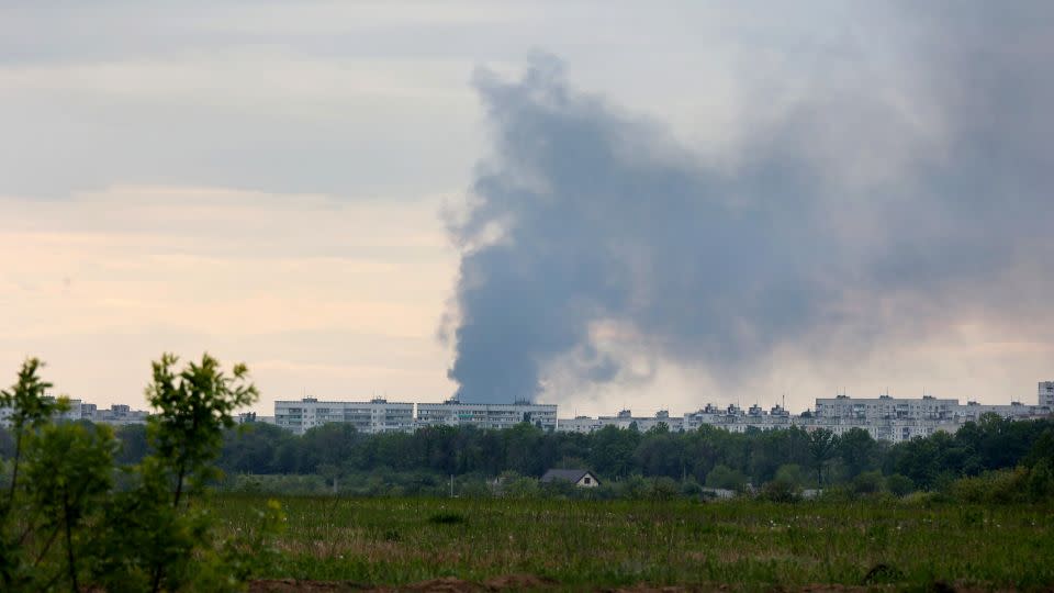 A pillar of smoke rises from behind apartment blocks after the shelling of Russian troops in Kharkiv on Friday. - Ukrinform/NurPhoto/Getty Images