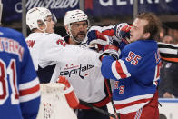 Washington Capitals' John Carlson (74) and Alex Ovechkin (8) fight with New York Rangers' Ryan Lindgren (55) during the third period in Game 2 of an NHL hockey Stanley Cup first-round playoff series Tuesday, April 23, 2024, in New York. (AP Photo/Frank Franklin II)