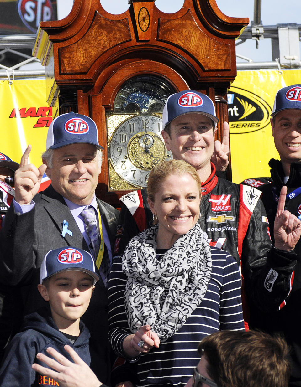 Clay Campbell, left, president of Martinsville Speedway celebrates in victory lane with race winner Kurt Busch, right, Patricia Driscoll, Busch's girlfriend and her son, Houston after a NASCAR Sprint Cup auto race at Martinsville, Speedway in Martinsville, VA., Sunday March 30, 2014. (AP Photo/Mike McCarn)