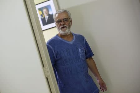 Joao Paulo de Oliveira, former organizer of the metalworkers union and current president of AMA-A (Association of Amnestied Metalworkers), walks past a photograph of Brazil's former President Luiz Inacio Lula da Silva, at his office in Sao Bernardo do Campo, near Sao Paulo July 22, 2014. Picture taken July 22, 2014. REUTERS/Nacho Doce