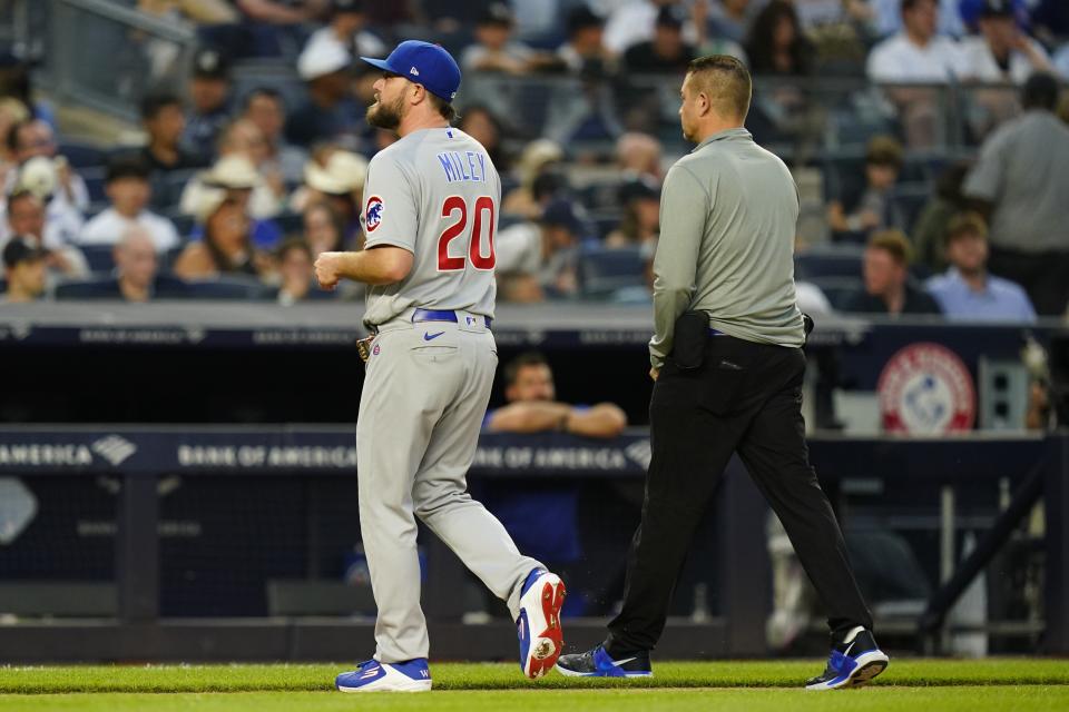 Chicago Cubs' pitcher Wade Miley, left, leaves during the fourth inning of a baseball game against the New York Yankees, Friday, June 10, 2022, in New York. (AP Photo/Frank Franklin II)