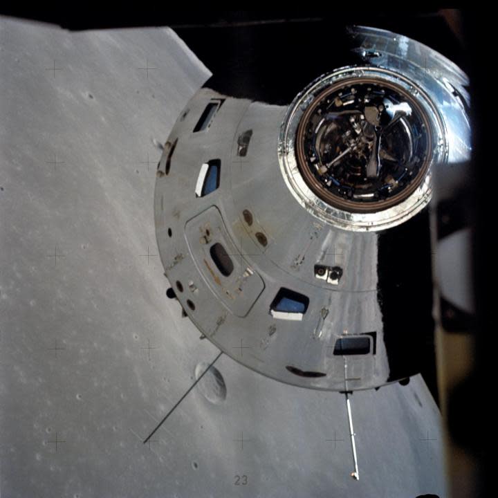 In this view, taken from the Lunar Module (LM), the Command and Service Module (CSM) are seen preparing to rendezvous with the LM. Note the reflection of the lunar surface on the CSM. (NASA)