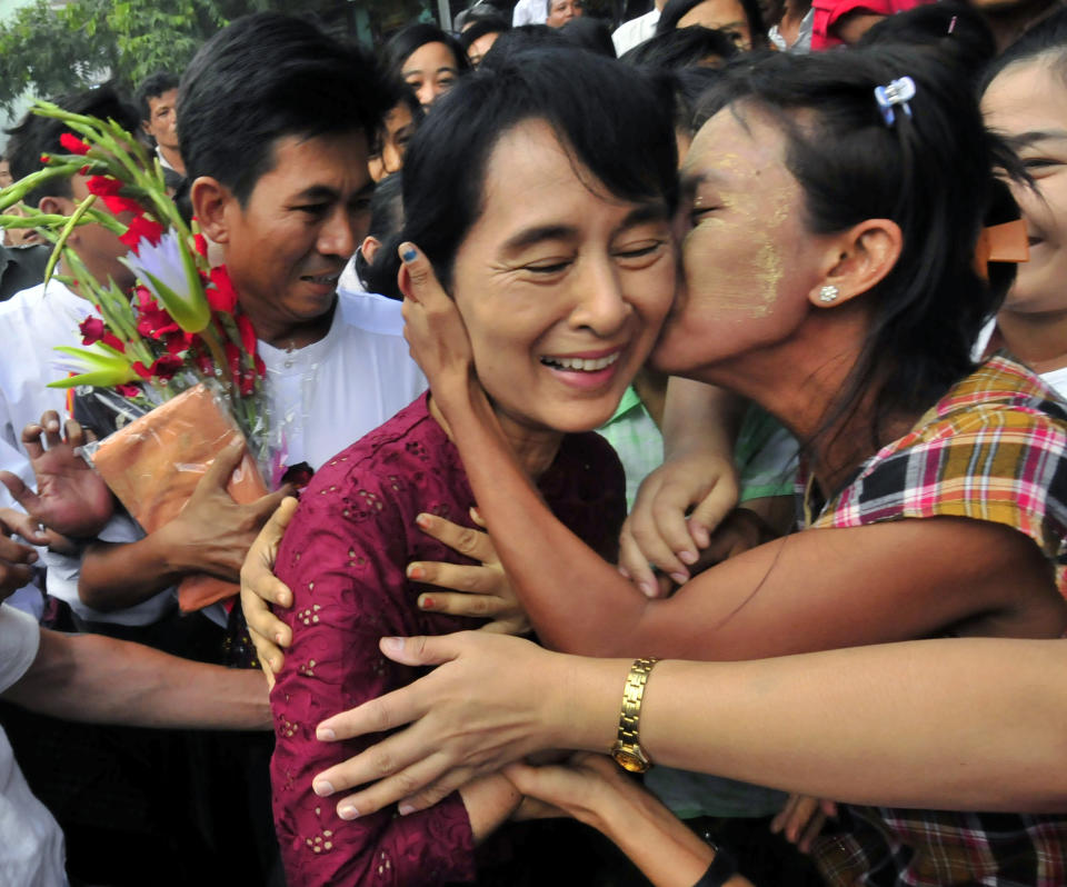 FILE - In this July 7, 2019, file photo, one of the villagers welcoming Myanmar democracy icon Aung San Suu Kyi kisses her as she visits Nyaung Oo market in Nyaung U village, Myanmar. There was a time when Suu Kyi was the hero of the human rights set, whose nonviolent struggle against her country's military dictatorship was admired by people around the world and won her the Nobel Peace Prize in 1991. Now she is seen by many of her admirers as an apologist for war crimes against its Muslim Rohingya minority. (AP Photo/Khin Maung Win)