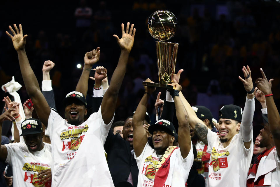 OAKLAND, CALIFORNIA - JUNE 13:  The Toronto Raptors celebrate with the Larry O'Brien Championship Trophy after their team defeated the Golden State Warriors to win Game Six of the 2019 NBA Finals at ORACLE Arena on June 13, 2019 in Oakland, California. NOTE TO USER: User expressly acknowledges and agrees that, by downloading and or using this photograph, User is consenting to the terms and conditions of the Getty Images License Agreement. (Photo by Ezra Shaw/Getty Images)