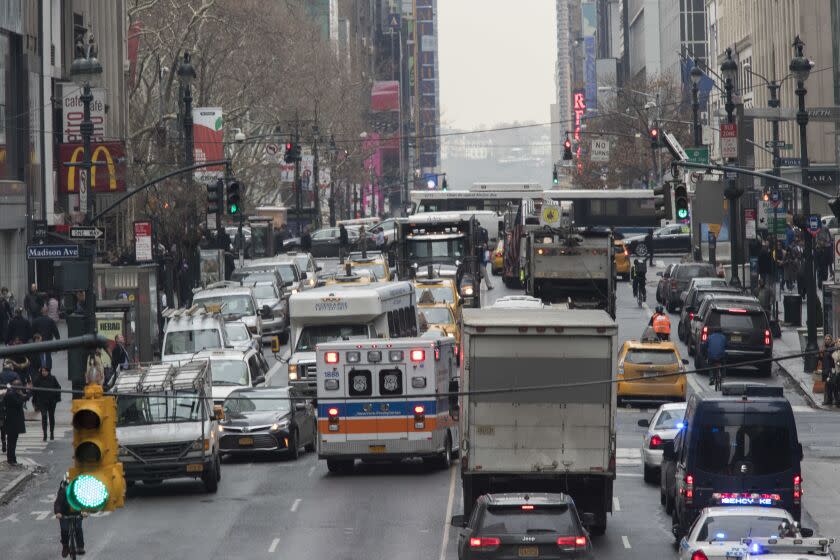 FILE- In this Jan. 11, 2018 photo, an ambulance is seen driving in the wrong lane to get around traffic on 42nd Street in New York. New York Gov. Andrew Cuomo and fellow Democrats who control the Legislature are making tough choices as they try to get a spending plan in place by an April 1 deadline. A proposal to implement motor vehicle congestion pricing in Manhattan to fund the city's ailing transit system is still alive in the negotiations. (AP Photo/Mary Altaffer)