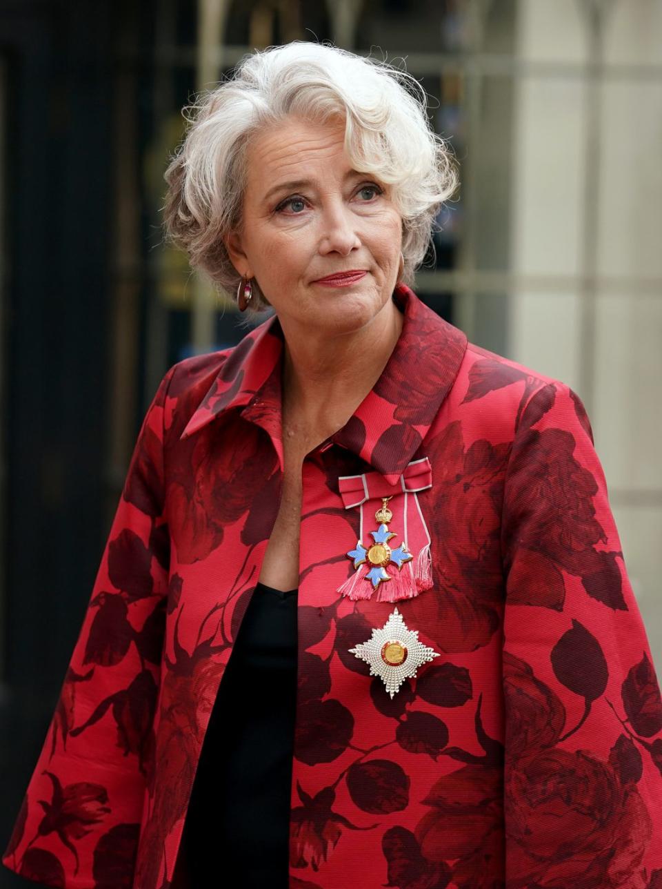 actress emma thompson arrives at westminster abbey ahead of the coronation of king charles iii and queen camilla wearing a red floral jacket