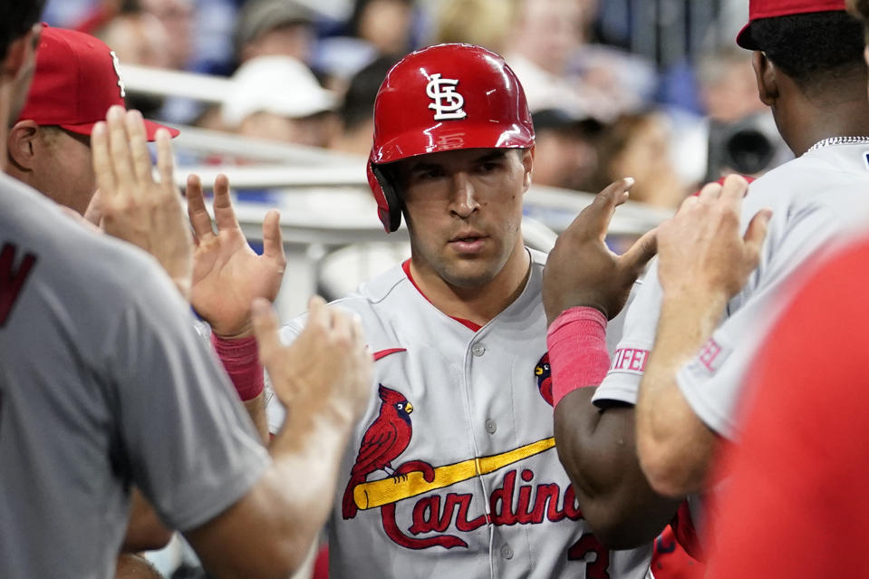 St. Louis Cardinals' Dylan Carlson is congratulated in the dugout after scoring on a groundout by Paul Goldschmidt against the Miami Marlins during the fourth inning of a baseball game Wednesday, July 5, 2023, in Miami. (AP Photo/Lynne Sladky)