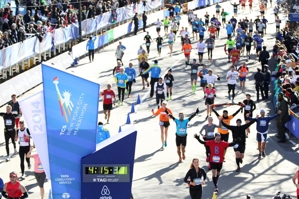 Runners cross the finish line of the New York City Marathon