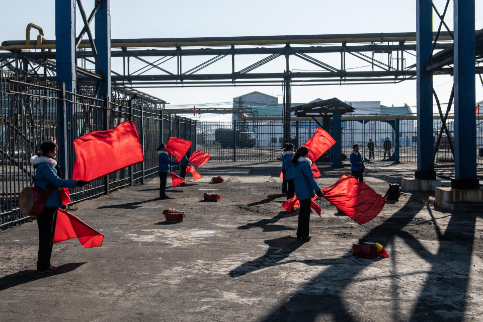 Female workers practice choreographed flag-waving in Hungnam Fertilizer Complex on Feb. 4 in Hamhung, North Korea.