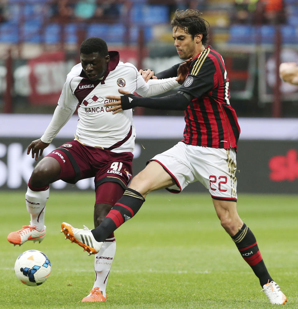 AC Milan Brazilian forward Kaka, right, challenges for the ball with Livorno midfielder Joseph Duncan, of Ghana, during the Serie A soccer match between AC Milan and Livorno at the San Siro stadium in Milan, Italy, Saturday, April 19, 2014. (AP Photo/Antonio Calanni)