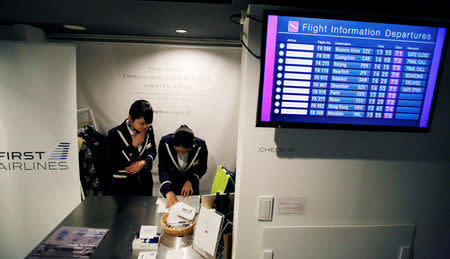 Staff dressed as flight attendants, work at the "First Airlines", virtual first-class airline experience facility in Tokyo, Japan February 14, 2018. Picture taken February 14, 2018. REUTERS/Toru Hanai