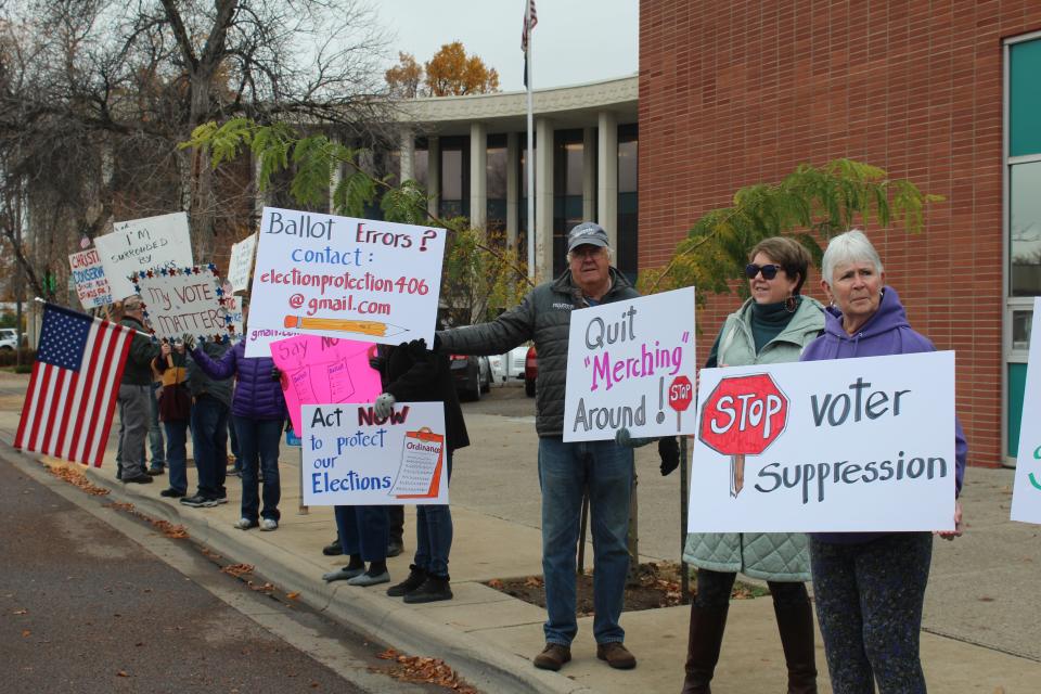 Demonstrators rallied Monday to demand that Cascade County commissioners strip Clerk and Recorder Sandra Merchant of her election duties.