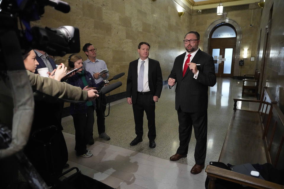 CAPTION CORRECTION CORRECTS IDENTIFICATIONS: Mike Davis, the founder and president of the Article III Project, center left, and Donald Trump's campaign adviser Jason Miller, talk outside the courtroom before beginning a hearing for a lawsuit that seeks to keep former President Donald Trump off the state ballot Monday, Oct. 30, 2023, in Denver. (AP Photo/Jack Dempsey, Pool)