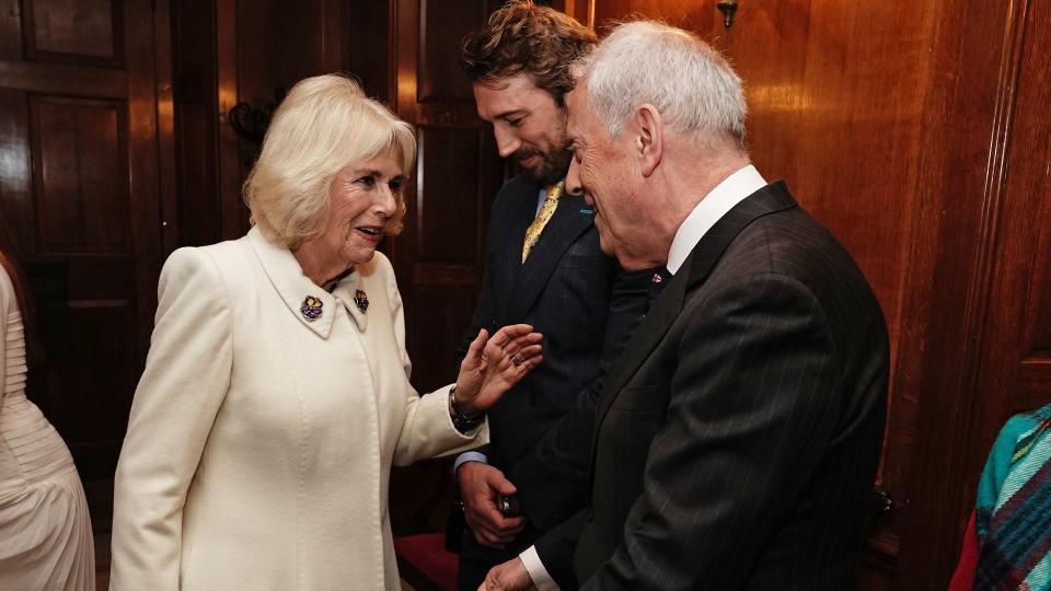 Queen Camilla speaks with Gyles Brandreth,