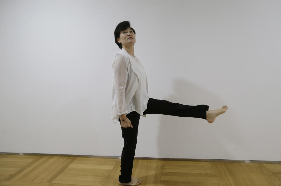 In this Aug. 28, 2018, photo, North Korean defector Kim Jungah shows how to do North Korean military goose steps during an interview in Seoul, South Korea. Goose-stepping soldiers are the most spectacular part of North Korea’s massive military parades. Kim, was once proud of her marching but now feels she was physically abused. (AP Photo/Ahn Young-joon)