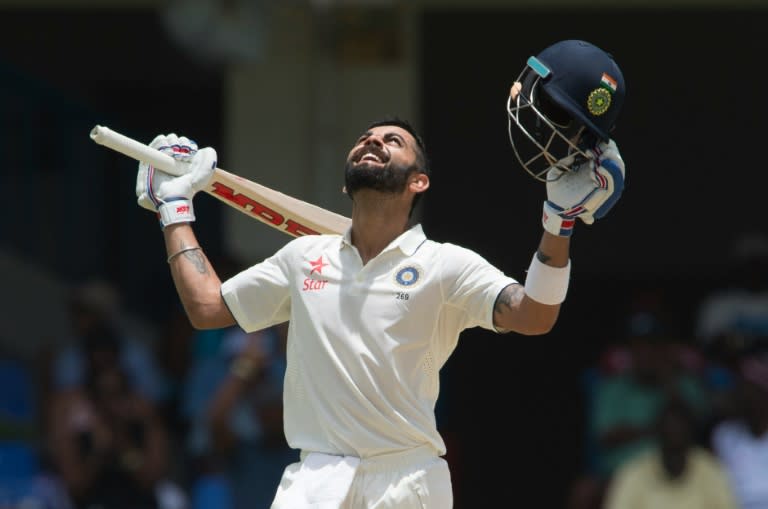 India cricketer Virat Kohli celebrates after batting 200 runs during day two of the cricket test match between West Indies and India on July 22, 2016